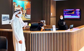 Receptionist helping clients at the front desk
