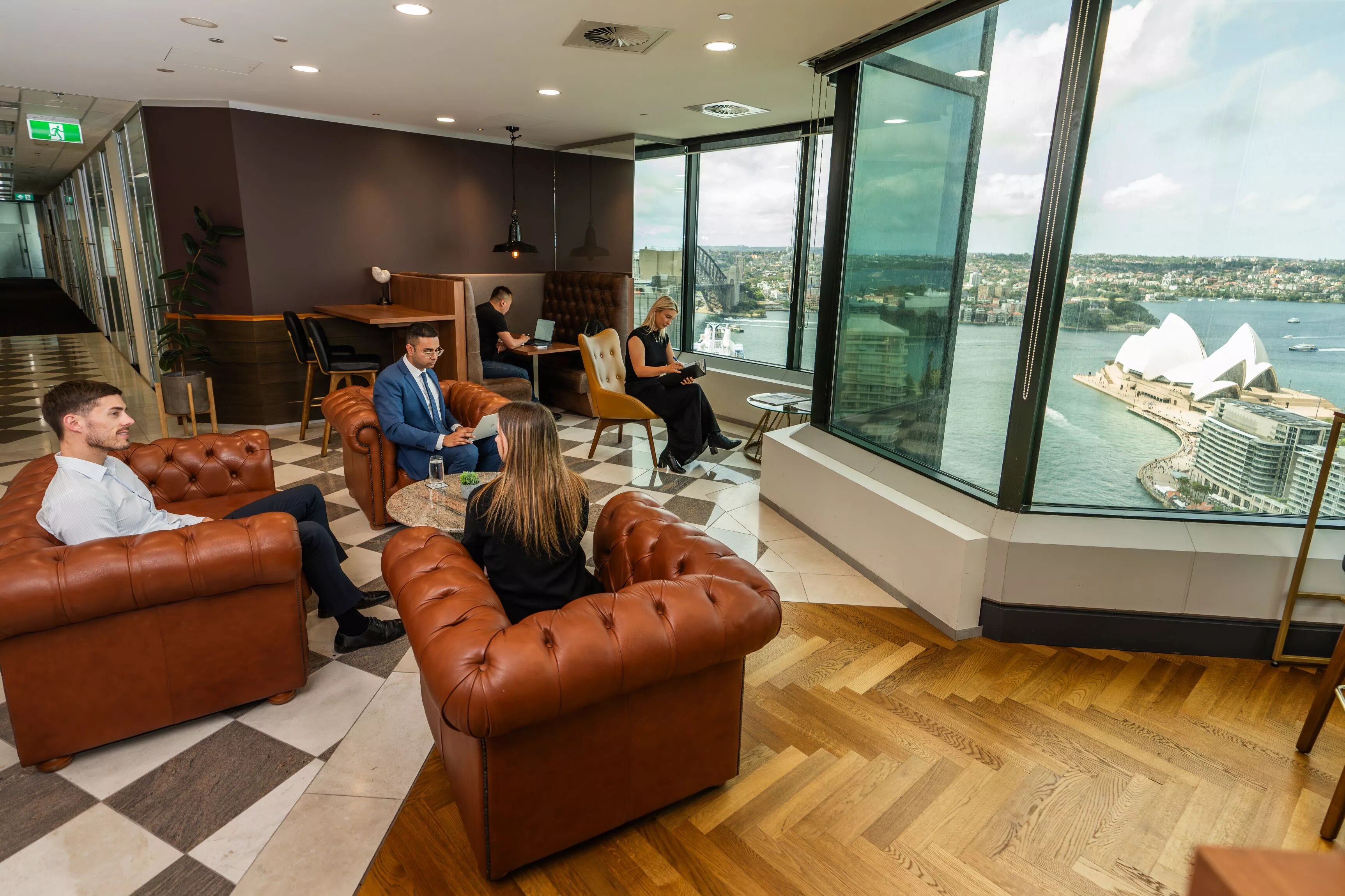 People enjoying their time in a modern coworking space in Servcorp Gateway with an impressive view