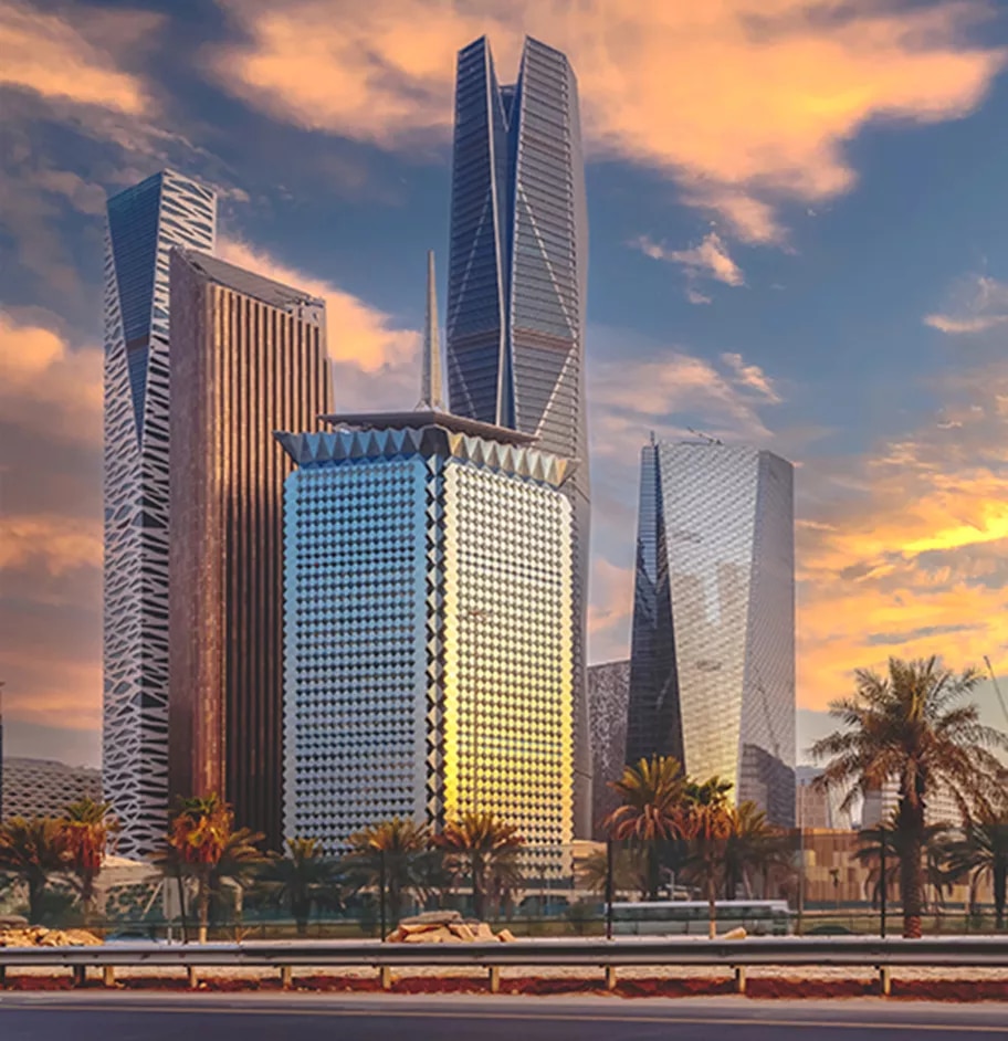 The skyline of King Abdullah Financial District (KAFD) glows at sunset, highlighting its striking architectural towers and palm-lined surroundings—symbolizing Riyadh’s thriving business future.