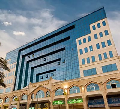 Abu Ouf Plaza in Madinah features a distinctive blue-glass façade and traditional architectural elements, offering Servcorp clients a prestigious business presence in the holy city.