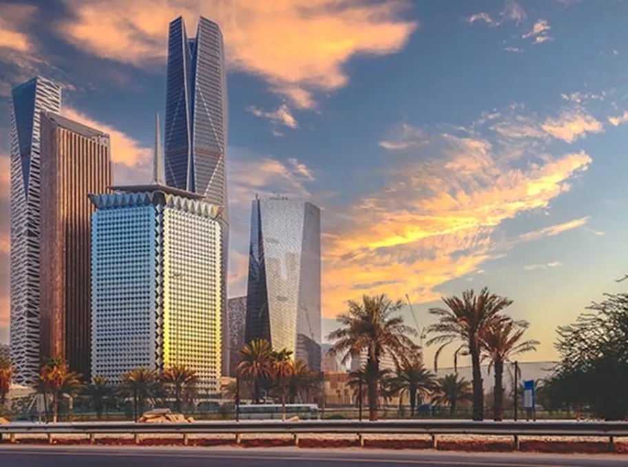 he skyline of King Abdullah Financial District (KAFD) glows at sunset, highlighting its striking architectural towers and palm-lined surroundings—symbolizing Riyadh’s thriving business future.